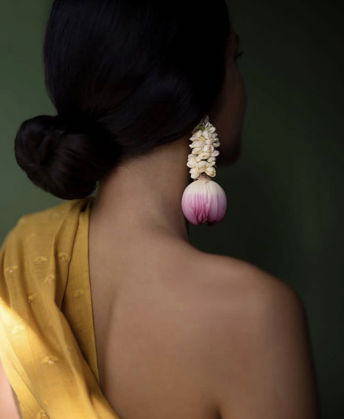Beautiful floral earrings on person of color